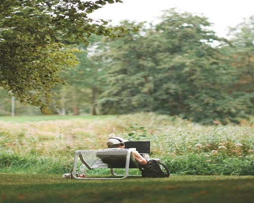 Person relaxing in a park away from screens