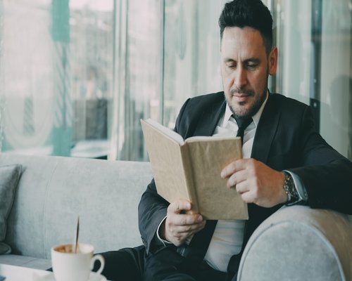 Reading a book in a cafe